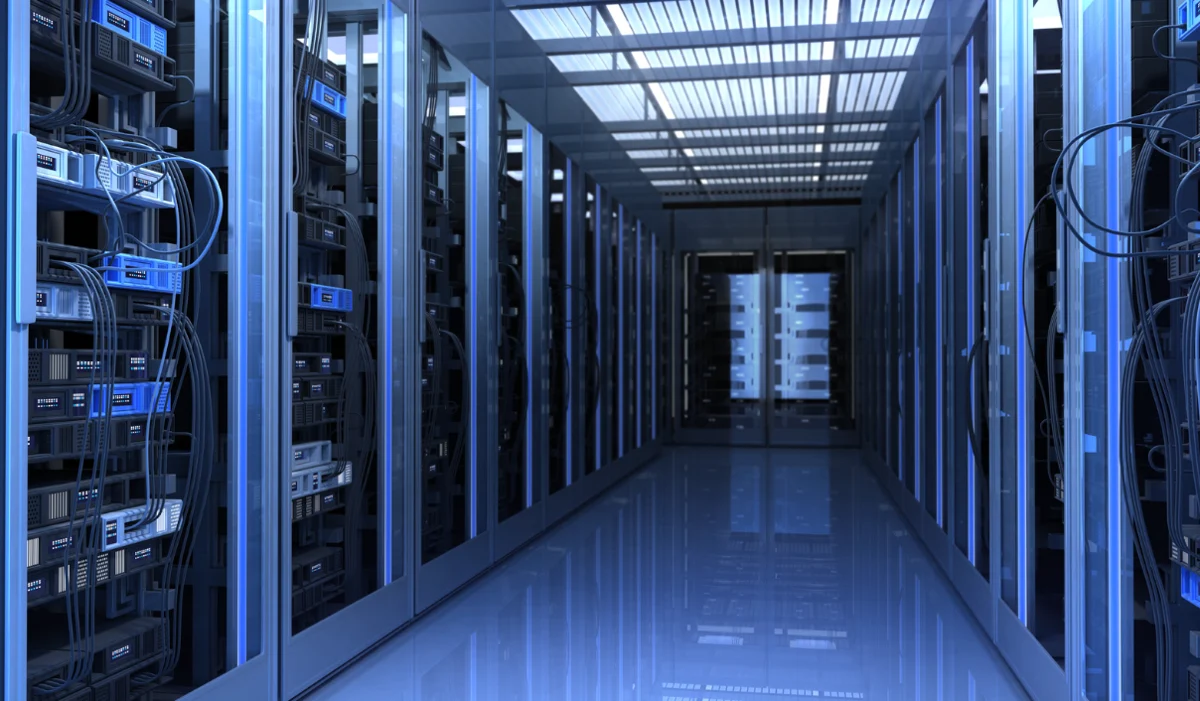 Modern data center corridor with rows of high-density server racks and networking equipment, designed for secure and scalable IT infrastructure